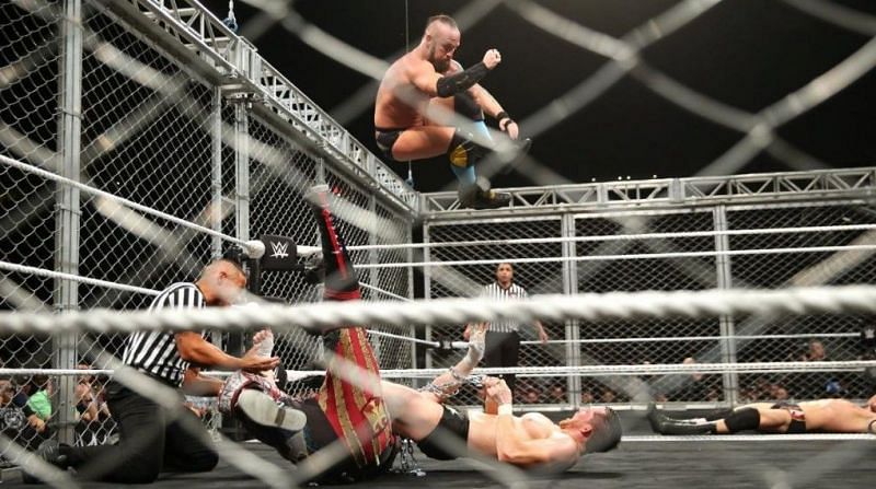 NXT Takeover: Wargames. Eric Young of Sanity drops his signature elbow onto Undisputed Era's Kyle O'Reilly, while Alexander Wolf is trapped in an armbar submission.